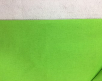 May include: A solid green fabric swatch. The fabric has a smooth, even texture.