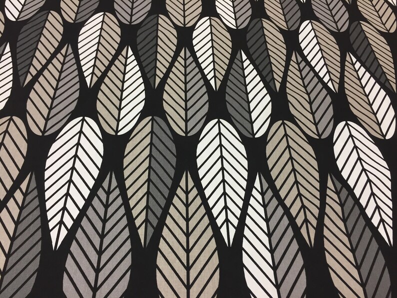 May include: Black fabric with a repeating pattern of stylized leaves in shades of gray and beige.