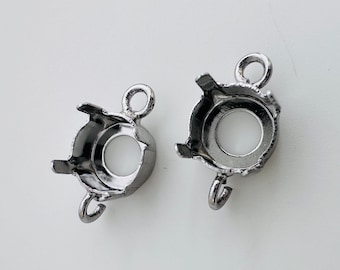 Könnte beinhalten: Zwei silberfarbene Metallfassungen zum Befestigen eines runden Edelsteins oder Cabochons. Jede Fassung hat eine Öse oben und eine Krappenfassung unten.