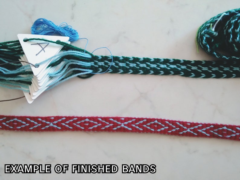 May include: Two examples of finished woven bands. The top band is green and blue, the bottom band is red and blue. The text "EXAMPLE OF FINISHED BANDS" is at the bottom of the image.