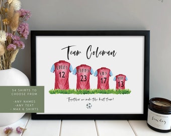 May include: A personalized printable art print featuring a watercolor illustration of a family wearing soccer jerseys. The jerseys are burgundy with blue accents and have names and numbers on the back. The text "Team Coleman" is at the top of the print, and the text "Together we make the best team!" is at the bottom. The print is surrounded by a black frame.
