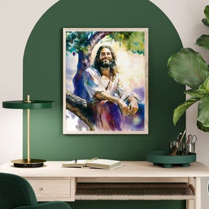 May include: A watercolor painting of a man with long hair and a beard sitting on a tree branch. He is wearing a long robe and has a peaceful expression on his face. The painting is set against a background of green trees and a bright blue sky.