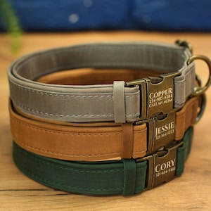 May include: Three dog collars stacked on top of each other. The top collar is gray, the middle collar is brown, and the bottom collar is green. Each collar has a metal buckle with a personalized name and phone number. The top collar says "Copper 214-987-4284 Call My Mom", the middle collar says "Jessie 121-564-1233", and the bottom collar says "Cory 321-654-5401".