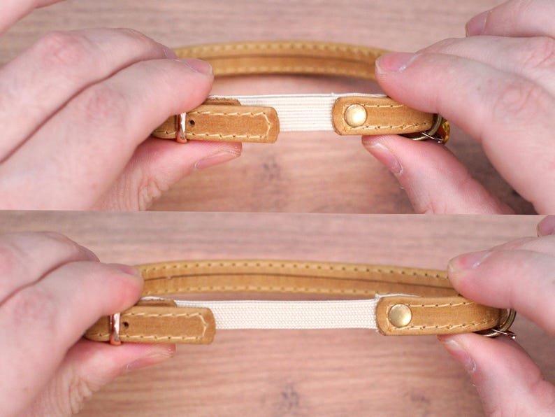 May include: A brown leather collar with a white elastic insert. The collar has a gold metal buckle and a gold metal rivet.