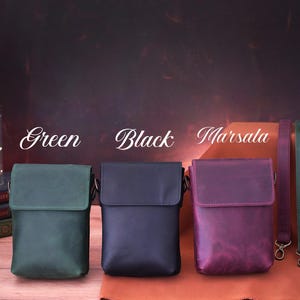 May include: Three leather crossbody bags in green, black, and marsala. Each bag has a flap closure and adjustable strap. The image also shows matching straps in coordinating colors. The word "Green", "Black", and "Marsala" are written above each bag.