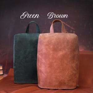 May include: Two leather bags, one green and one brown, with top handles. The bags are rectangular with rounded tops. The words "Green" and "Brown" are written above the bags in a script font.