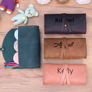 May include: Three personalized leather zippered pouches with the names Rachel, Abigail, and Kelly. The pouches are brown, tan, and pink.