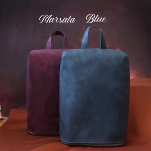 May include: Two rectangular bags, one in a deep burgundy and the other in a muted blue, each with a top handle and a zipper closure. The text "Marsala" and "Blue" are above the bags.