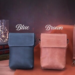 May include: Two leather crossbody bags, one blue and one brown, with matching straps. The bags have a rectangular shape with a flap closure. The word "Blue" and "Brown" are written above each bag.
