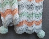 Hand-crocheted Chevron baby blanket with pom poms - aqua, coral, white gray