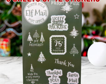 May include: Five sheets of 12 waterproof vinyl stickers with a Christmas theme. The stickers feature images of Christmas trees, stars, and text such as "Elf Mail", "Holly Jolly Package", "Joy Delivered", "The North Pole 25¢ Official Postal Stamp", "Thank You", "We Wish You a Very Merry Christmas", "Thankful for You!" and "Santa Mail".