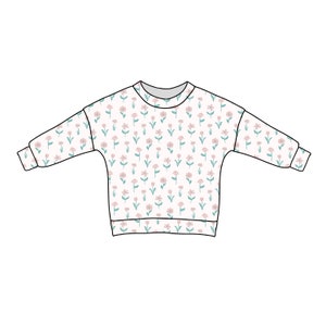 Pode incluir: Uma camisa de manga comprida branca com estampa floral com flores rosa e verdes.