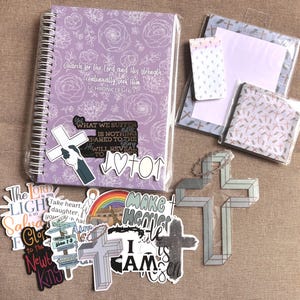 May include: A collection of religious-themed stickers and a purple spiral notebook with a floral design and the text "Search for the Lord and His strength; continually seek Him 1 Chronicles 16:11".