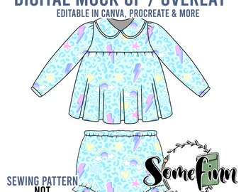 May include: Digital mock-up of a baby girl's outfit. The outfit includes a blue long-sleeved dress with a white collar and a matching blue diaper cover. The dress and diaper cover have a pattern of rainbows, hearts, stars, and lightning bolts on a light blue background.