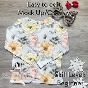 May include: A white long-sleeved shirt with a floral pattern of pink and yellow roses. The shirt is on a wooden surface with a snowflake ornament and a pair of reindeer antlers glasses. The text "Easy to edit Mock Up/Overlay" is at the top of the image. The text "Some Finn Graphics" is at the bottom of the image. The text "Skill Level: Beginner" is at the bottom right of the image.