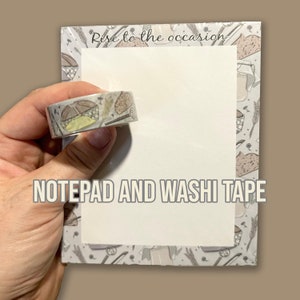 May include: A white notepad with a gray and white patterned border. The notepad has the text "Rise to the occasion" printed on the top. A roll of washi tape with a brown and white pattern is shown in the image. The text "NOTEPAD AND WASHI TAPE" is printed below the notepad.