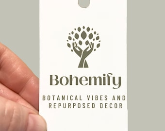 May include: White tag with a green logo of two hands holding a tree with leaves. The text "Bohemify" is below the logo, and the text "Botanical Vibes and Repurposed Decor" is below that.