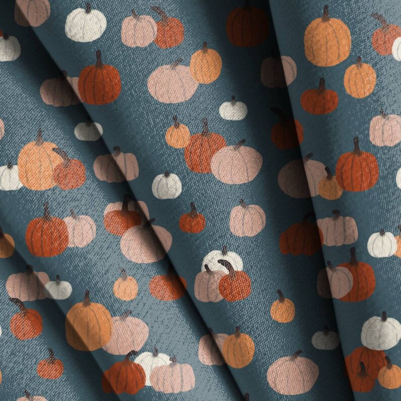 May include: A seamless pattern featuring various shades of orange, pink, and white pumpkins on a blue background. The pumpkins are arranged in a repeating pattern, creating a festive and autumnal design.
