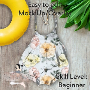 Op de afbeelding: Een wit, mouwloos topje met een bloemenpatroon in roze, gele en groene tinten. Het topje heeft een halternek-stijl en is perfect voor de zomer. De tekst "Skill Level: Beginner" is zichtbaar in de rechterbenedenhoek van de afbeelding.