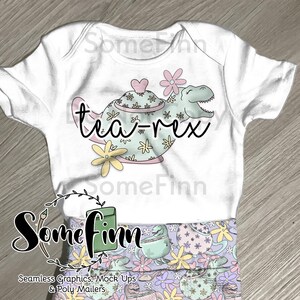 May include: A white baby onesie featuring a teapot shaped like a dinosaur with the text "tea-rex" on it. The onesie has a floral pattern on the teapot and dinosaur. The onesie is paired with matching leggings with a floral and dinosaur pattern.