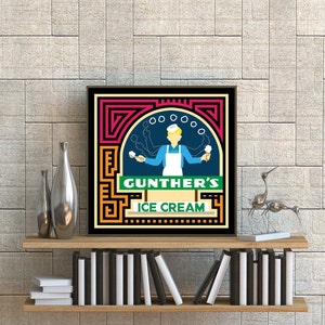 May include: A retro-style illustration of a man in a blue shirt and white apron holding ice cream cones. The illustration is framed in a black frame with a colorful geometric design. The text "GUNTHER'S ICE CREAM" is featured in the illustration.