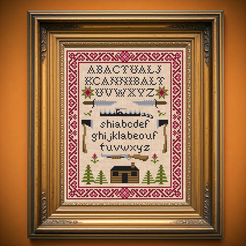 Peut inclure: Un motif de point de croix encadr&eacute; avec une cabane, des arbres et l'alphabet dans une police rustique. Les lettres sont dispos&eacute;es en un motif avec les lettres "A B A C T U A L L Y" en haut et "K C A N N I B A L T" en dessous. Le reste de l'alphabet est dispos&eacute; en rang&eacute;es en dessous. Le motif est entour&eacute; d'une bordure rouge et blanche.