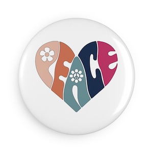May include: A white button featuring a peace sign within a heart shape. The heart is composed of various coloured sections, including pink, orange, blue, and green. The peace sign is white with a black outline. The word "peace" is spelled out in a stylised font inside the heart.