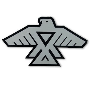 May include: A silver and black stylized eagle design with a geometric pattern. The eagle is in a flying position with its wings spread out.