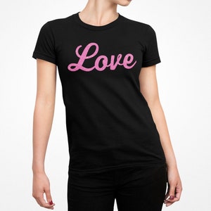 May include: Black t-shirt with a pink glitter "Love" graphic.