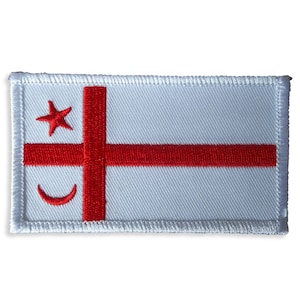 May include: White embroidered patch with a red cross and a red crescent moon and star.