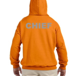 May include: Orange hooded sweatshirt with the word "CHIEF" in reflective silver lettering on the back.