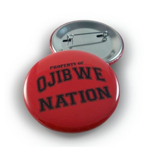May include: Red button with black text that reads "PROPERTY OF OJIBWE NATION".