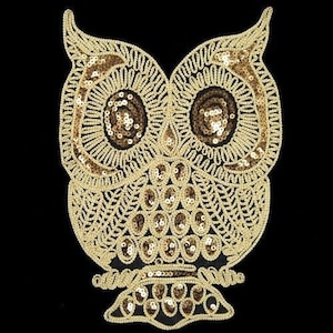 May include: Gold sequined owl applique with a detailed design. The owl has large eyes and a beak. The applique is perfect for adding a touch of sparkle to any project.