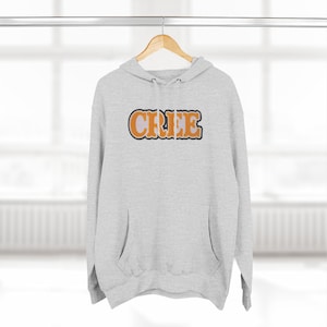 May include: A gray hooded sweatshirt with the word "CRIEE" printed in orange letters on the front.