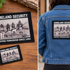 May include: Rectangular black and white embroidered patch featuring the text HOMELAND SECURITY at the top and FIGHTING TERRORISM SINCE 1492 at the bottom, with a central historical photograph of four Indigenous people holding rifles.