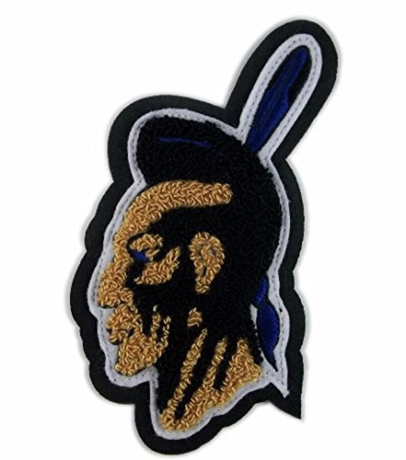 May include: A black and gold embroidered patch of an Native American profile with a blue and white feather headdress.