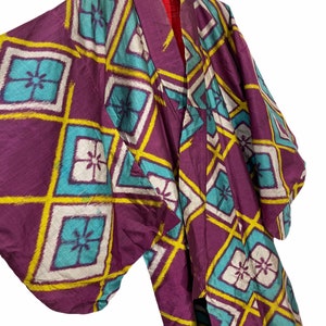 May include: A purple silk kimono with a geometric pattern of yellow, white, and blue diamonds. The kimono has a traditional Japanese design and is in good condition.