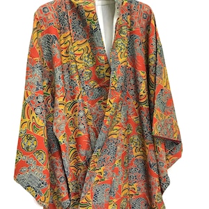 May include: A red and yellow kimono with a floral and wave pattern. The kimono is made of a lightweight fabric and has a relaxed fit.