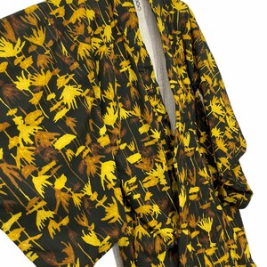 May include: A dark green kimono with a yellow floral pattern. The kimono is made of a soft, lightweight fabric and has a traditional Japanese design.