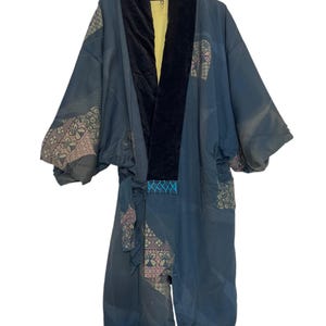May include: A dark blue kimono with a black velvet collar and a yellow lining. The kimono has a geometric pattern with pink and gold accents.