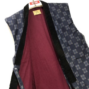 May include: A blue and white patterned sleeveless vest with a black velvet collar and trim. The vest is lined with a burgundy fabric. The vest has a label that reads "Japanese Style" in Japanese characters.