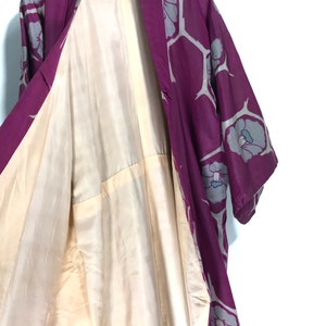 May include: A purple and gray silk kimono with a floral pattern. The kimono is open to reveal the cream-colored lining.