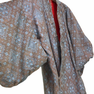 May include: A blue and brown patterned kimono with a red lining. The kimono has a traditional Japanese design.