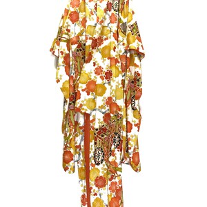 May include: A traditional Japanese kimono with a white background and a vibrant floral pattern in shades of orange, yellow, and red. The kimono is hanging, showcasing its full length and intricate design.