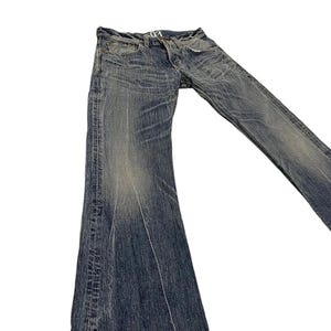 May include: Faded blue denim jeans with a flared leg design. The jeans have a worn appearance with visible fading and distressing. The stitching is visible in yellow. The jeans are laid flat against a white background.