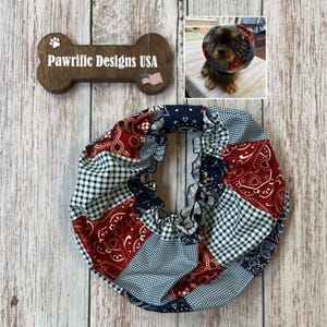 May include: A circular pet neck ruffle featuring a patchwork design of red and navy blue paisley patterns mixed with a blue and white gingham check fabric. The fabric is gathered with an elasticized center opening for a comfortable fit.