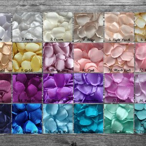 May include: A chart of 24 different colors of silk rose petals. The petals are arranged in rows of four, with each color labeled with a number and a name. The colors include white, ivory, cream, beige, light peach, light gold, old gold, gold, dusty rose, pink, blush pink, light pink, mauve, purple, light purple, lavender, lilac, light blue, royal blue, turquoise, mint, and emerald.