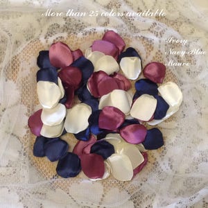 May include: A pile of ivory, burgundy, and navy blue satin flower petals. More than 25 colors available. Ivory, Navy Blue, Mauve.