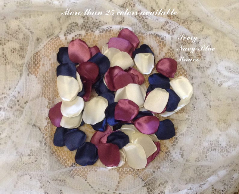 May include: A pile of ivory, burgundy, and navy blue satin flower petals. More than 25 colors available. Ivory, Navy Blue, Mauve.