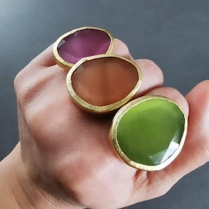 Bold brass cocktail rings with oval synthetic gemstone